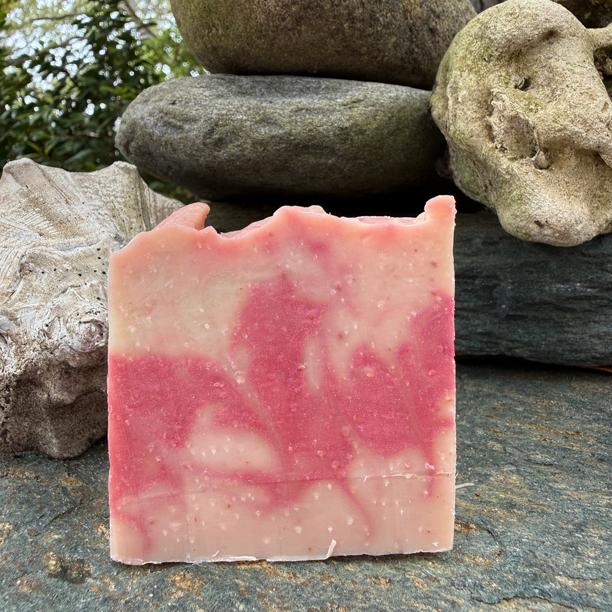 Appalachian Surf Soap Co Sun Kissed bar soap with pink swirls on a stone surface
