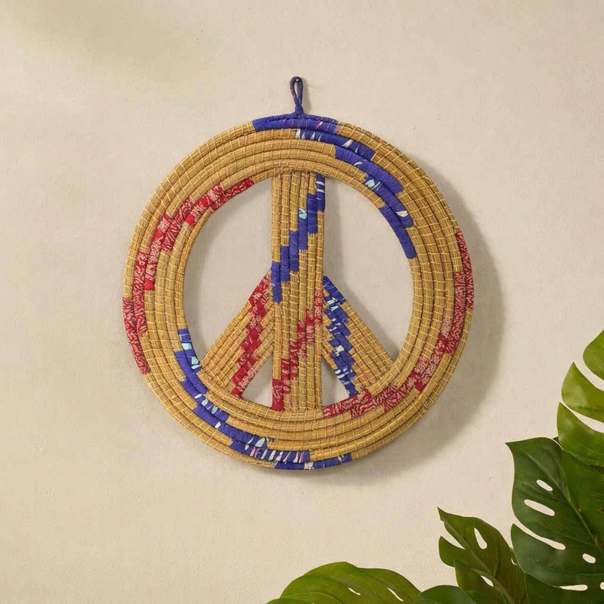 Serrv International upcycled sari peace wreath made of woven natural fibers and colorful fabric strips