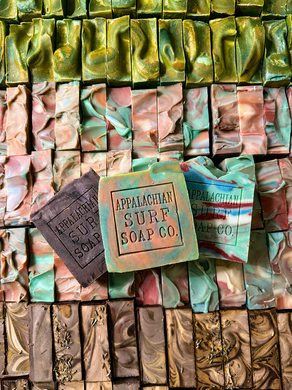 Rows of Appalachian Surf Soap Co bars with marbled green pink and brown textures