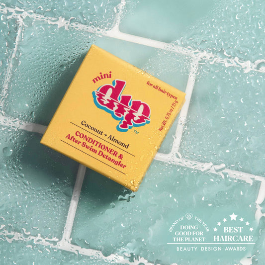 Dip Mini Conditioner and After Swim Detangler Coconut and Almond bar on wet blue tiles