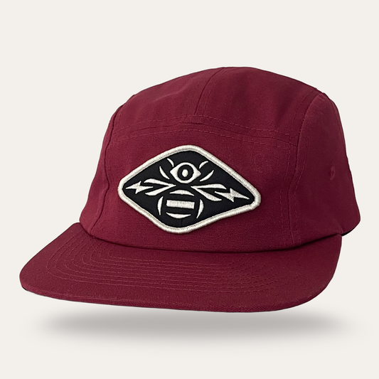 Sunday Lounge burgundy five panel cap with a black and white bee eye graphic patch