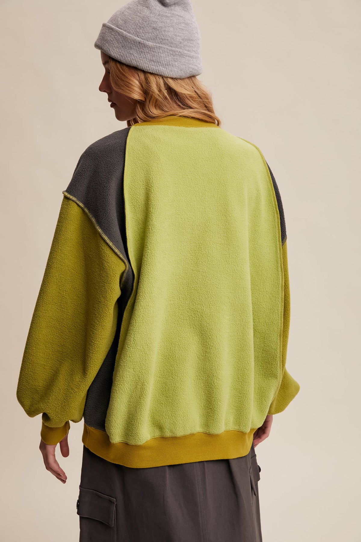 Back view of Listicle Colorblock Fleece Pullover LT1111 in green and grey with a grey beanie