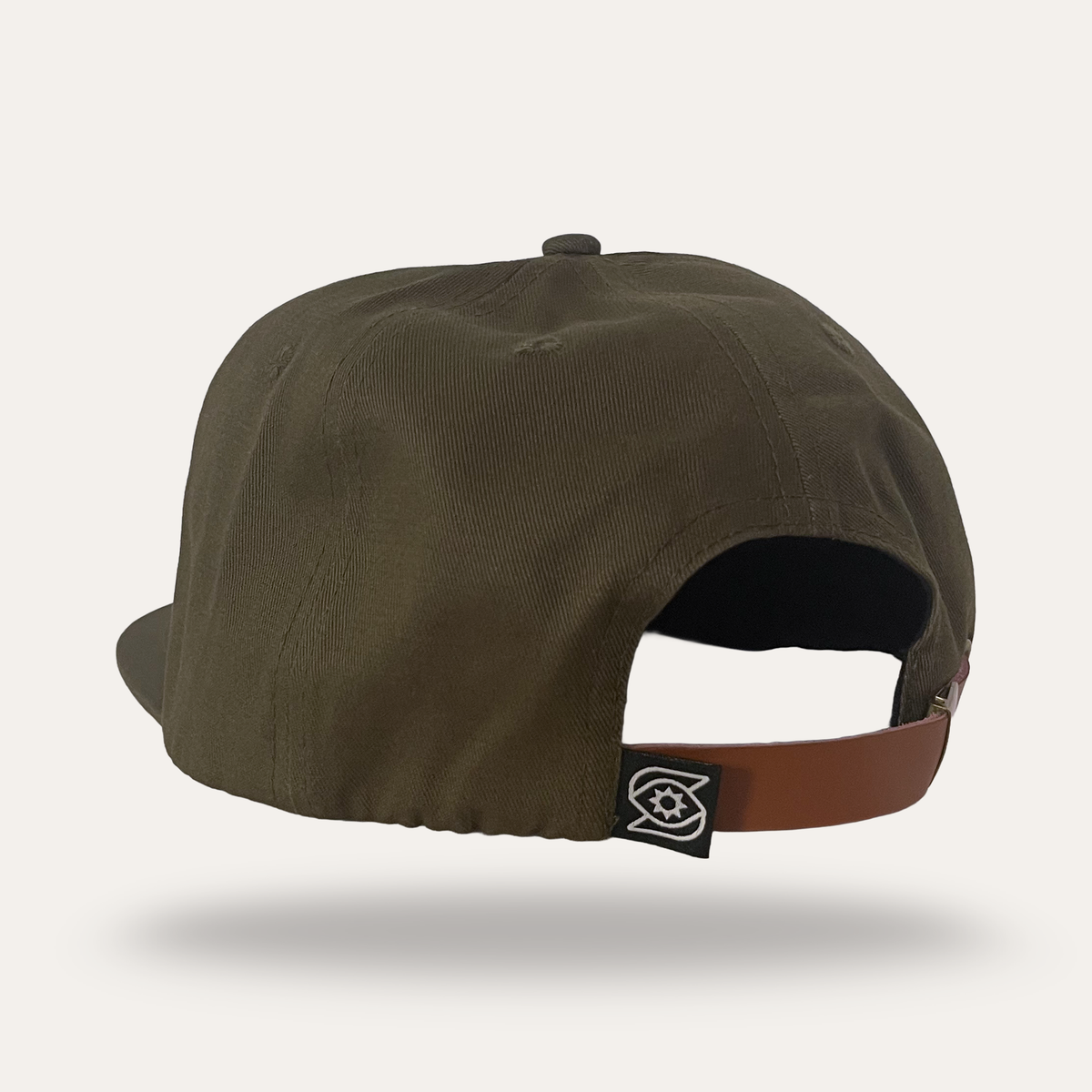 Back view of Sunday Lounge Mushroom Hat in forest cotton twill with brown leather strap and brand logo patch