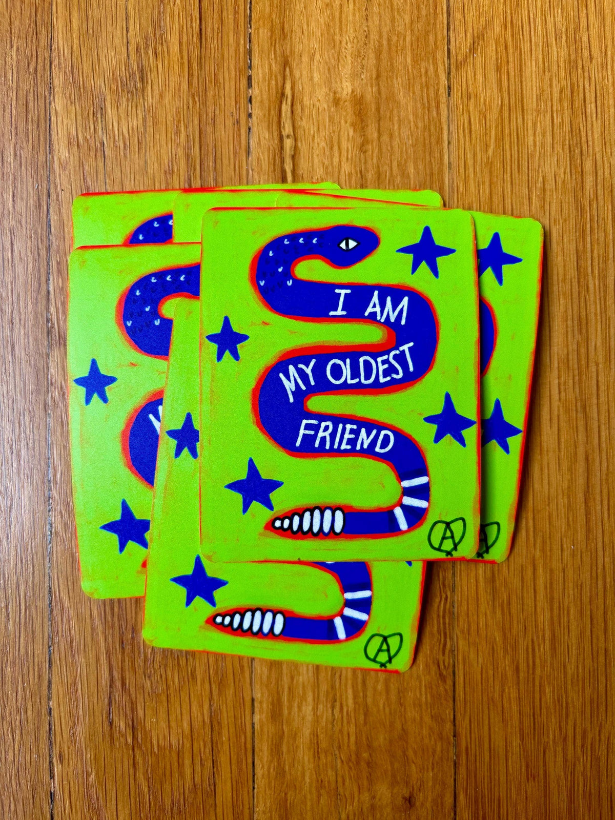 Anna Liz Heart Designs I Am My Oldest Friend snake sticker with blue snake and stars on a bright green background