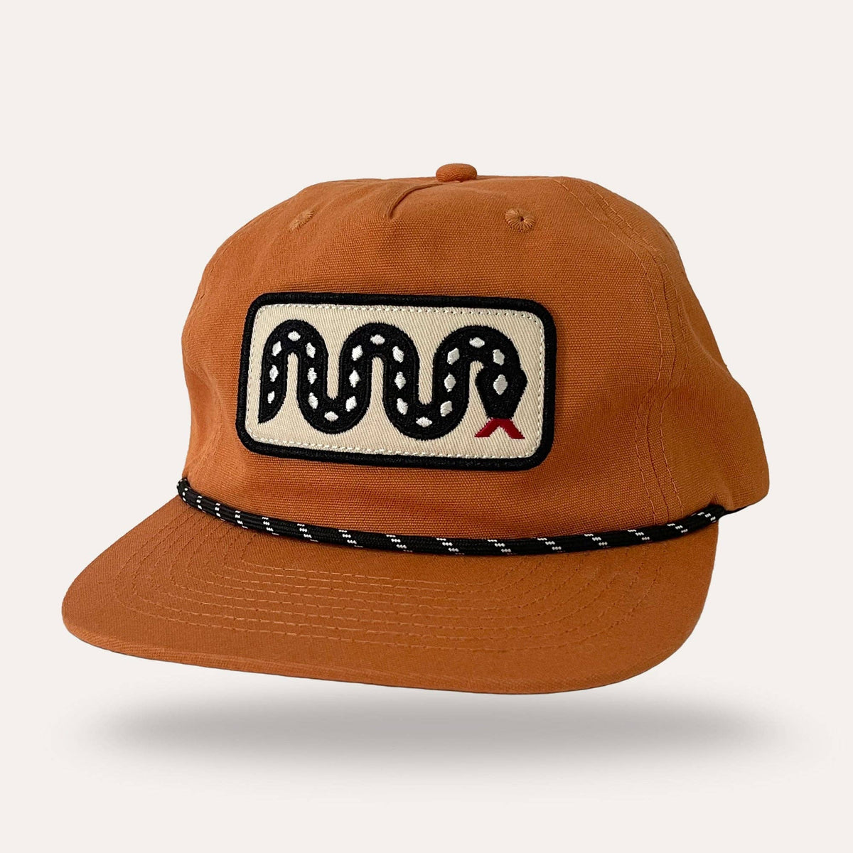 Sunday Lounge Snake Hat in desert orange with a snake graphic patch and black rope detail