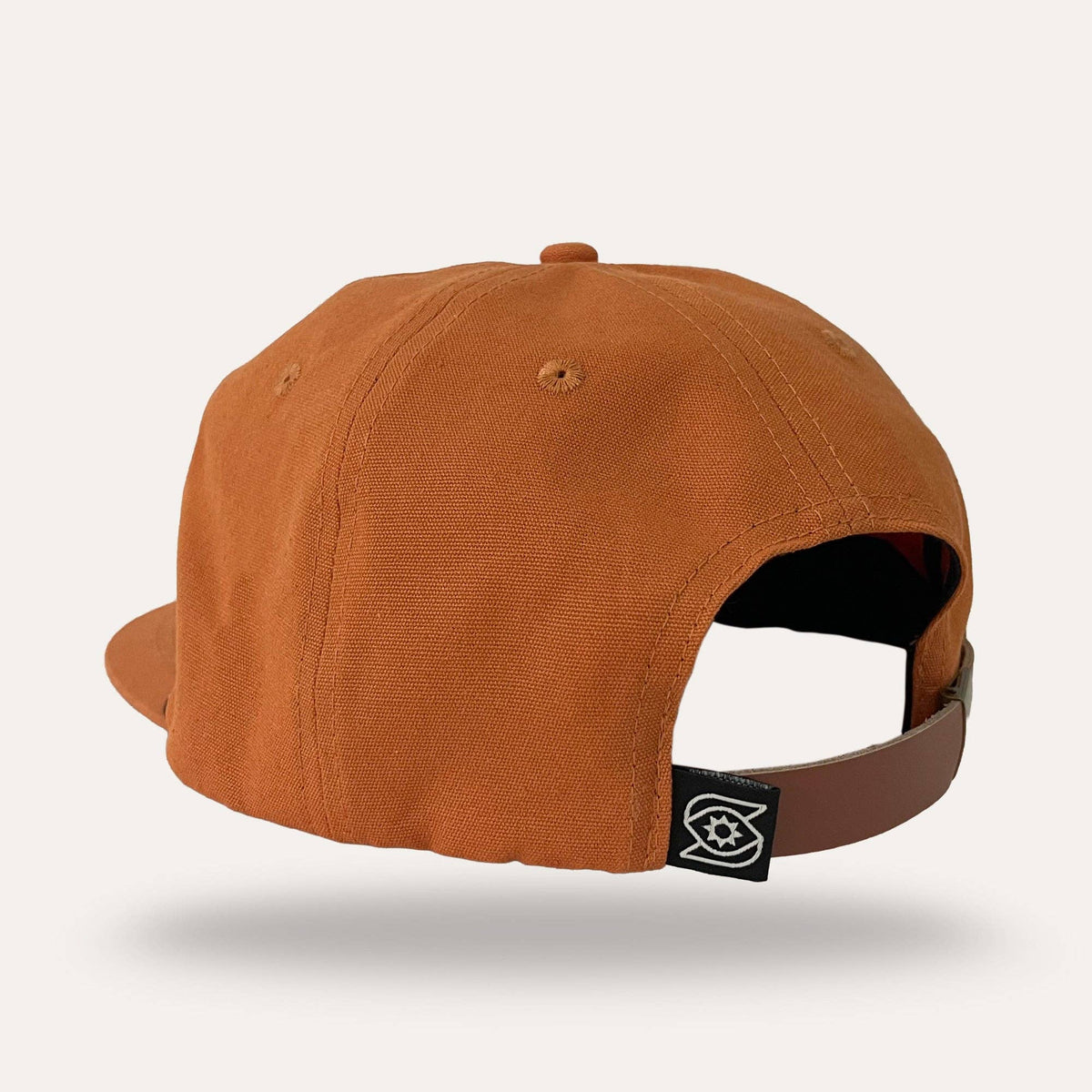 Back view of Sunday Lounge Snake Hat in desert orange with leather strap and brand logo tab