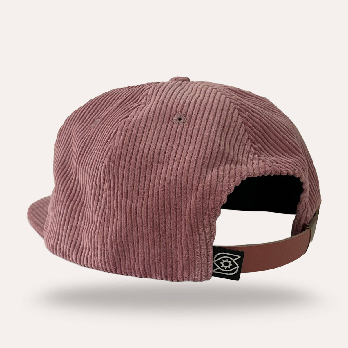Back view of pink corduroy Sunday Lounge Mushroom Hat with leather strap and brand logo tab