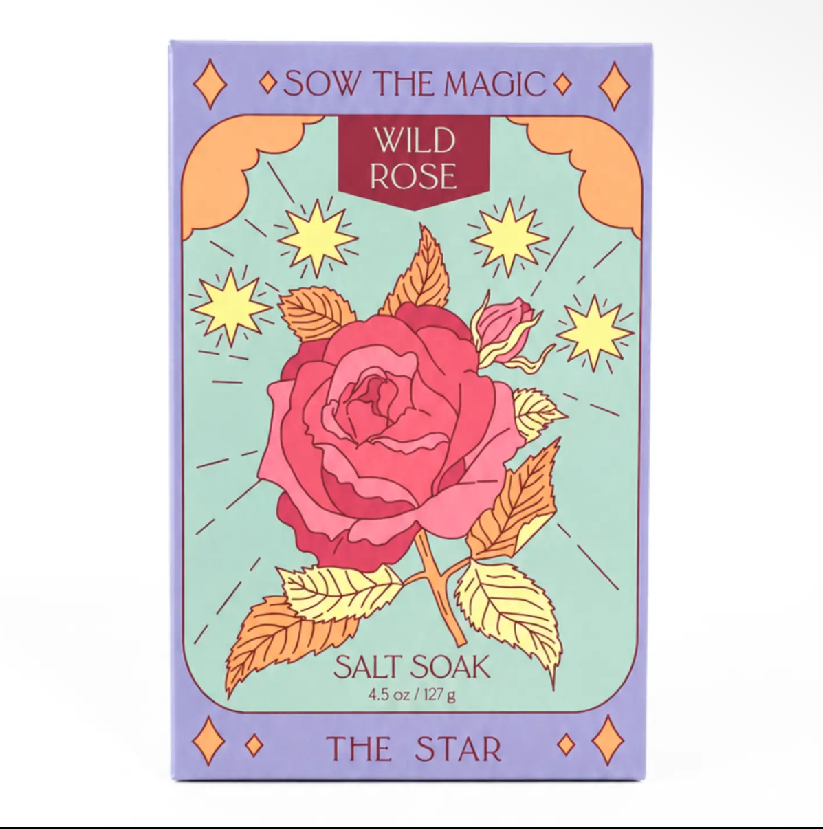 A tarot card product titled 'Sow the Magic: Wild Rose Salt Soak' featuring a central pink rose with yellow suns and leaves on a light green background, framed by a lavender border.