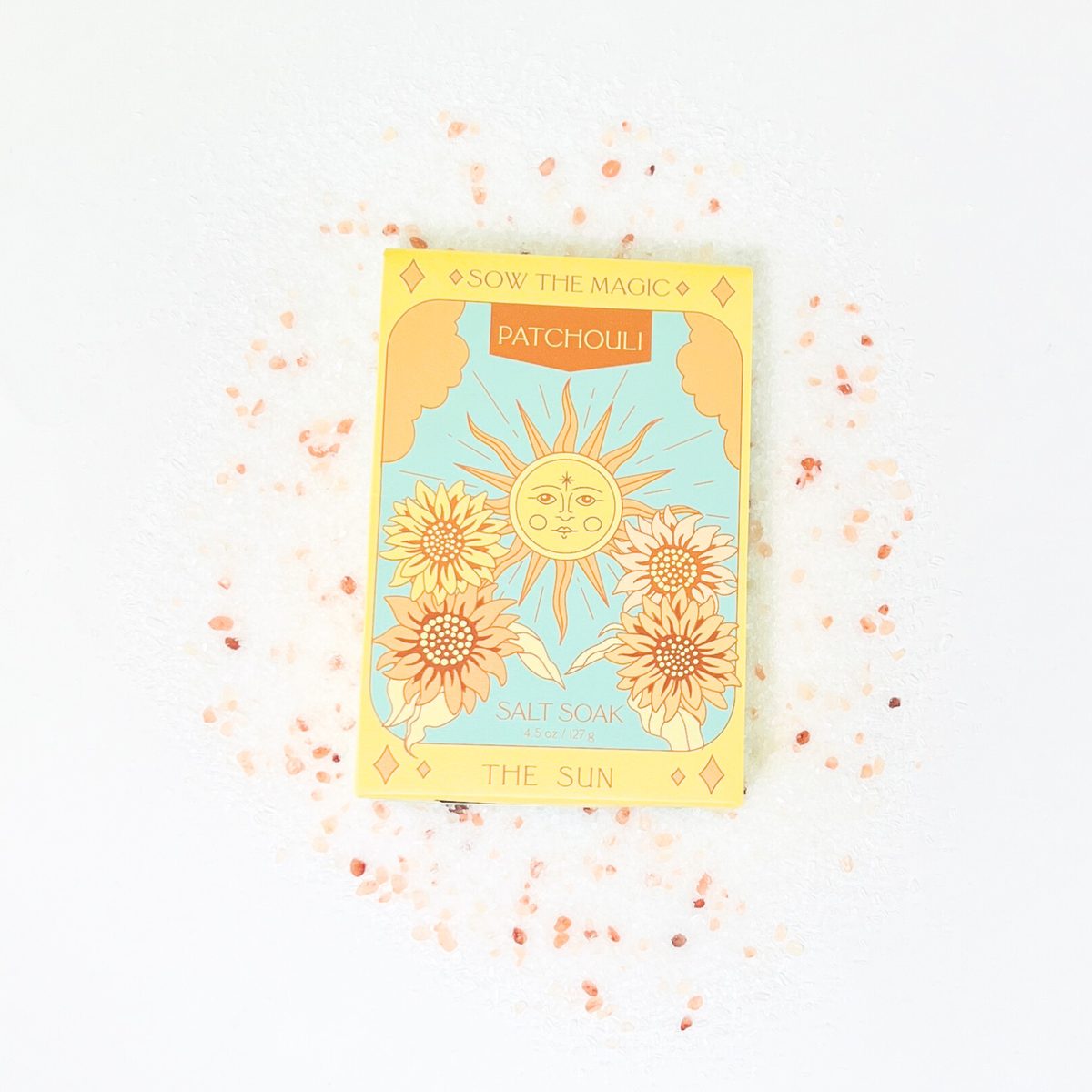 Sow the Magic The Sun Salt Soak in Patchouli box on a bed of pink Himalayan salt