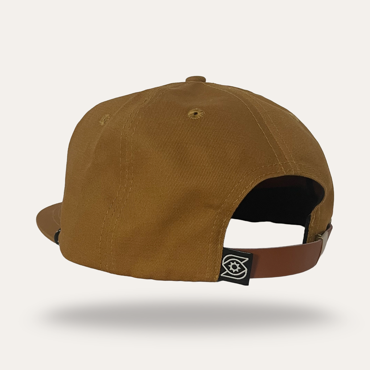 Back view of Sunday Lounge Spirit Wing Bird Hat in umber cotton twill with leather strap and logo tab
