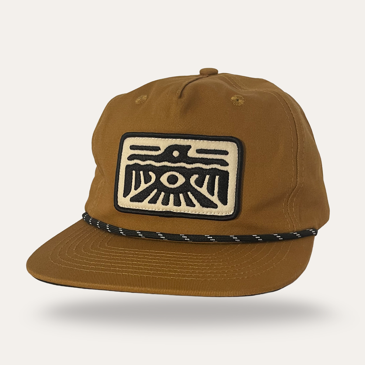 Sunday Lounge Spirit Wing Bird Hat in umber cotton twill with black and white bird graphic patch and rope detail