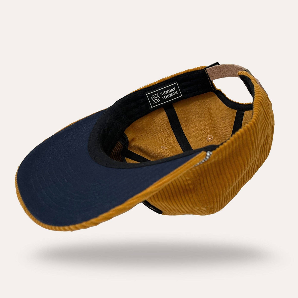 Interior view of mustard corduroy Sunday Lounge mushroom hat showing Sunday Lounge brand label