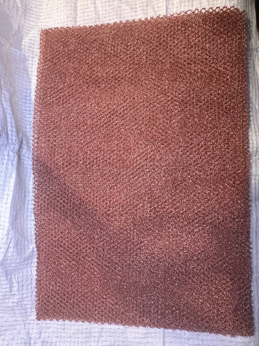 Fiori Essentials and Co African net sponge with a textured copper mesh surface