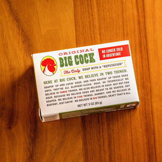 Whiskey River Soap Co Big Cock triple milled boxed bar soap with rooster graphic on wooden surface