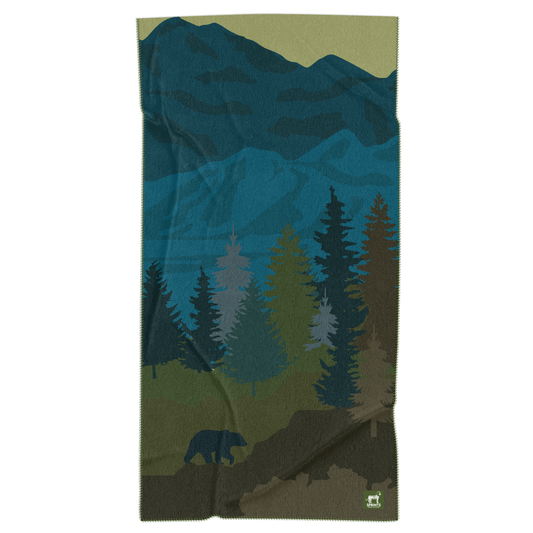 Fleece blanket with mountain and bear design on a white background