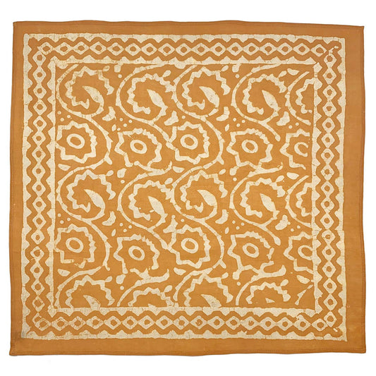 Patterned fabric square with orange and white design on a white background